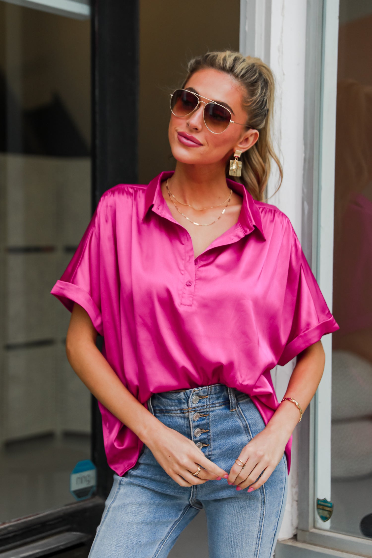 model wearing hot pink satin blouse