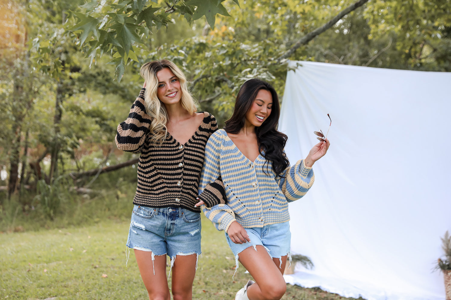 two models wearing fun and chunky striped sweaters