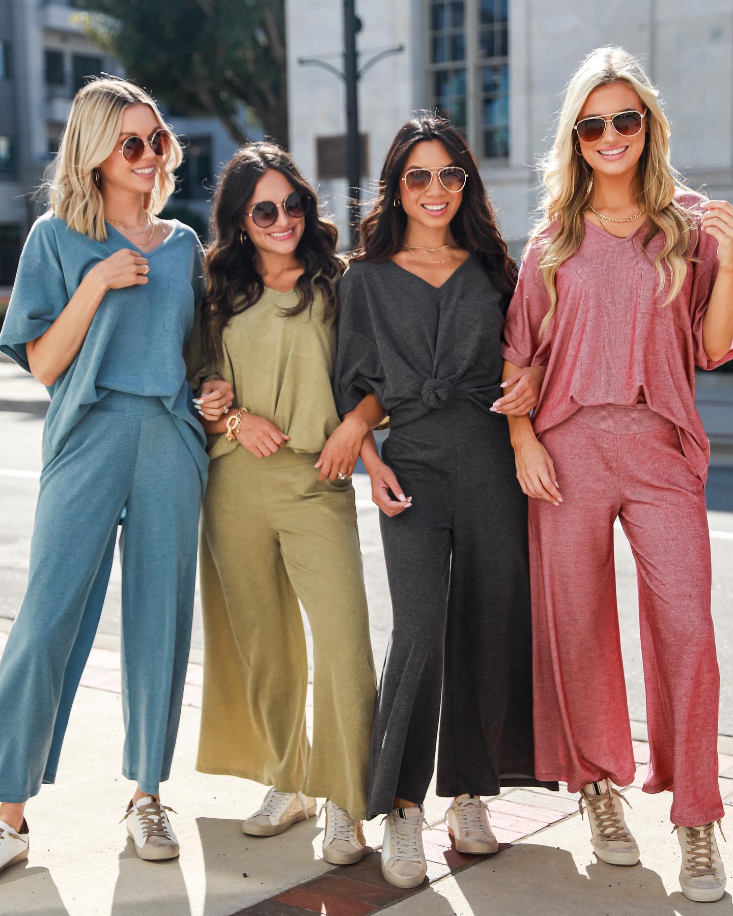 4 Dress Up models wearing matching sets in various colors