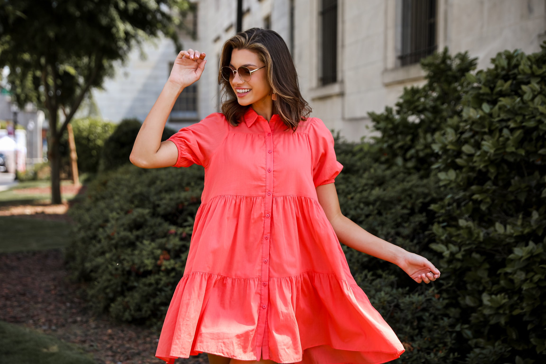 model wearing a coral mini dress