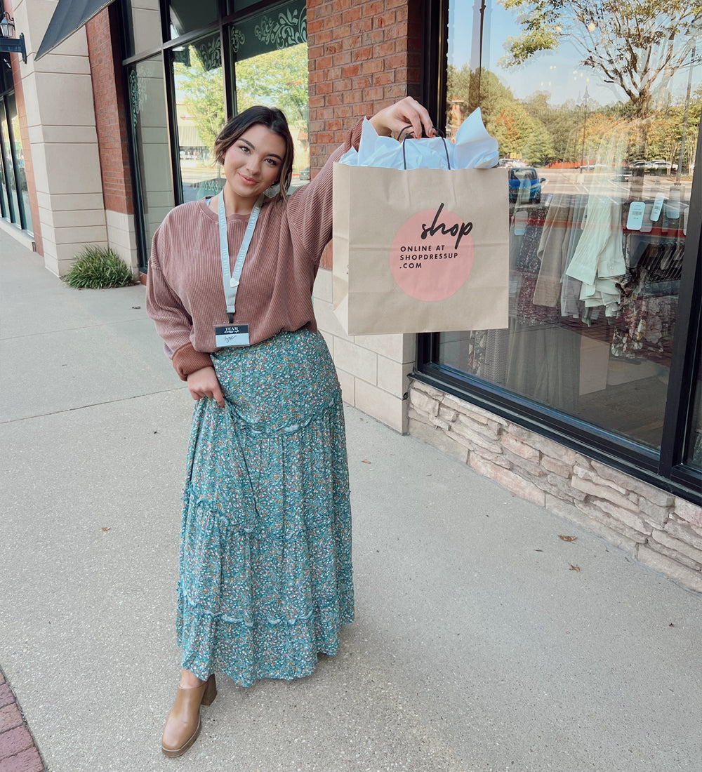 MODEL WEARING CUTE FLORAL TIERED MAXI SKIRT AND LIGHT KNIT SWEATER