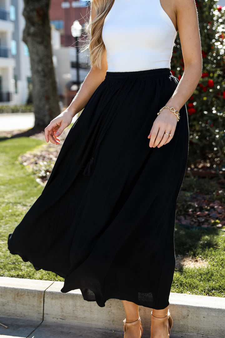 On My Mind Black Maxi Skirt has a flowy fit, elastic waistband, high-waisted skirt. Cute black skirt for summer. Pair with cute sandals, spring break outfit. online boutique 