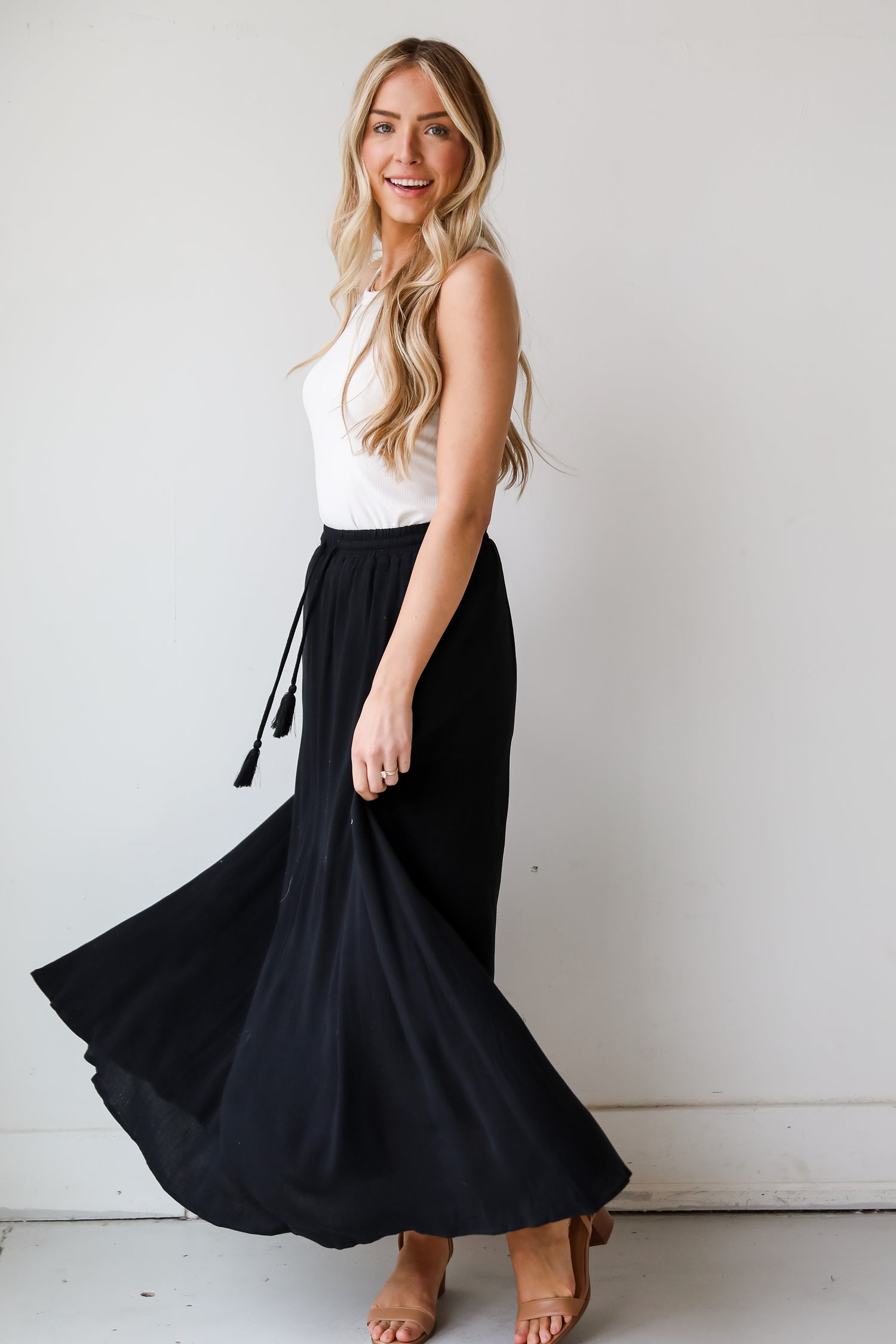 On My Mind Black Maxi Skirt has a flowy fit, elastic waistband, high-waisted skirt. Cute black skirt for summer. Pair with cute sandals, spring break outfit. online boutique 