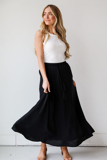 On My Mind Black Maxi Skirt has a flowy fit, elastic waistband, high-waisted skirt. Cute black skirt for summer. Pair with cute sandals, spring break outfit. online boutique 