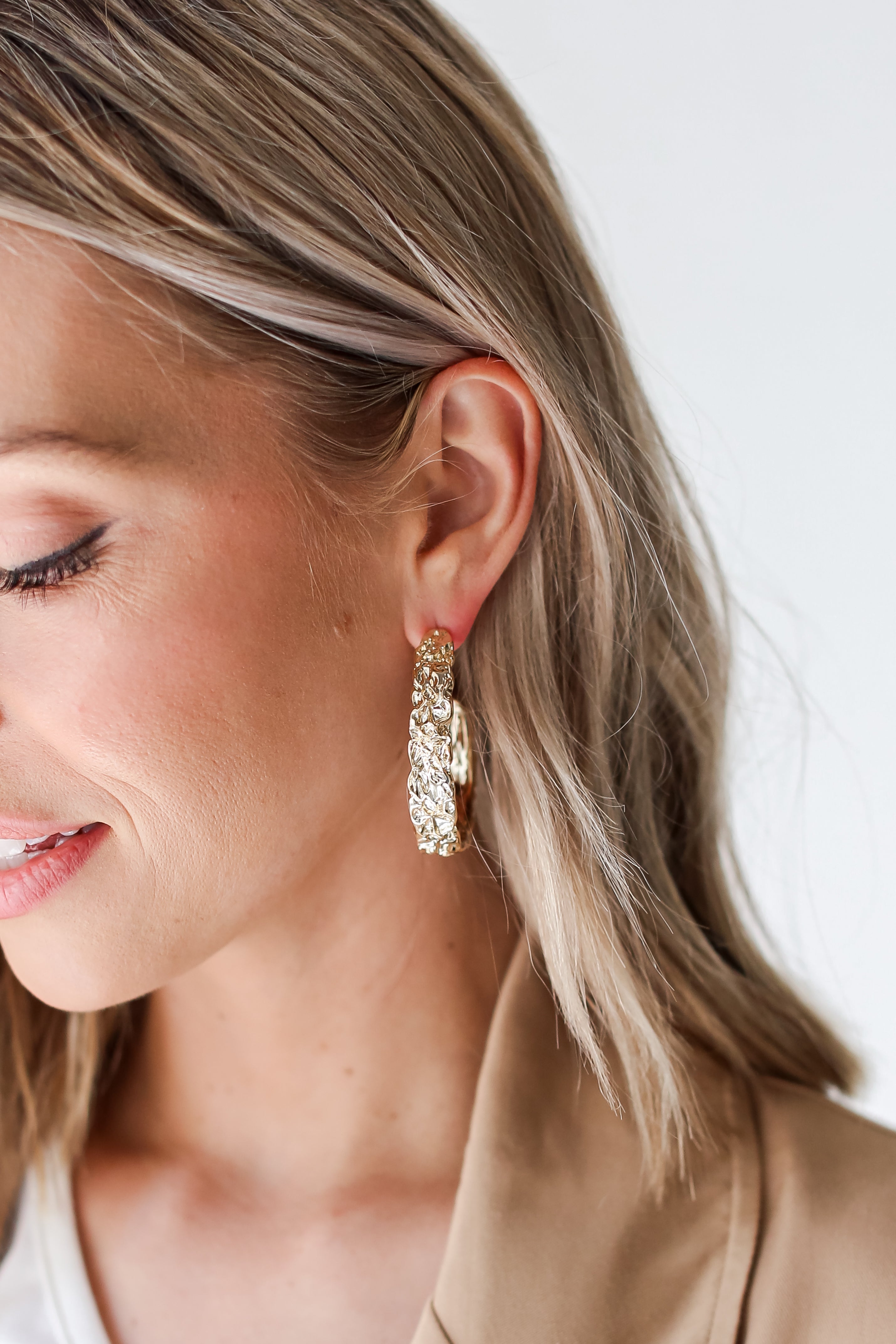 Gold Hammered Hoop Earrings on model