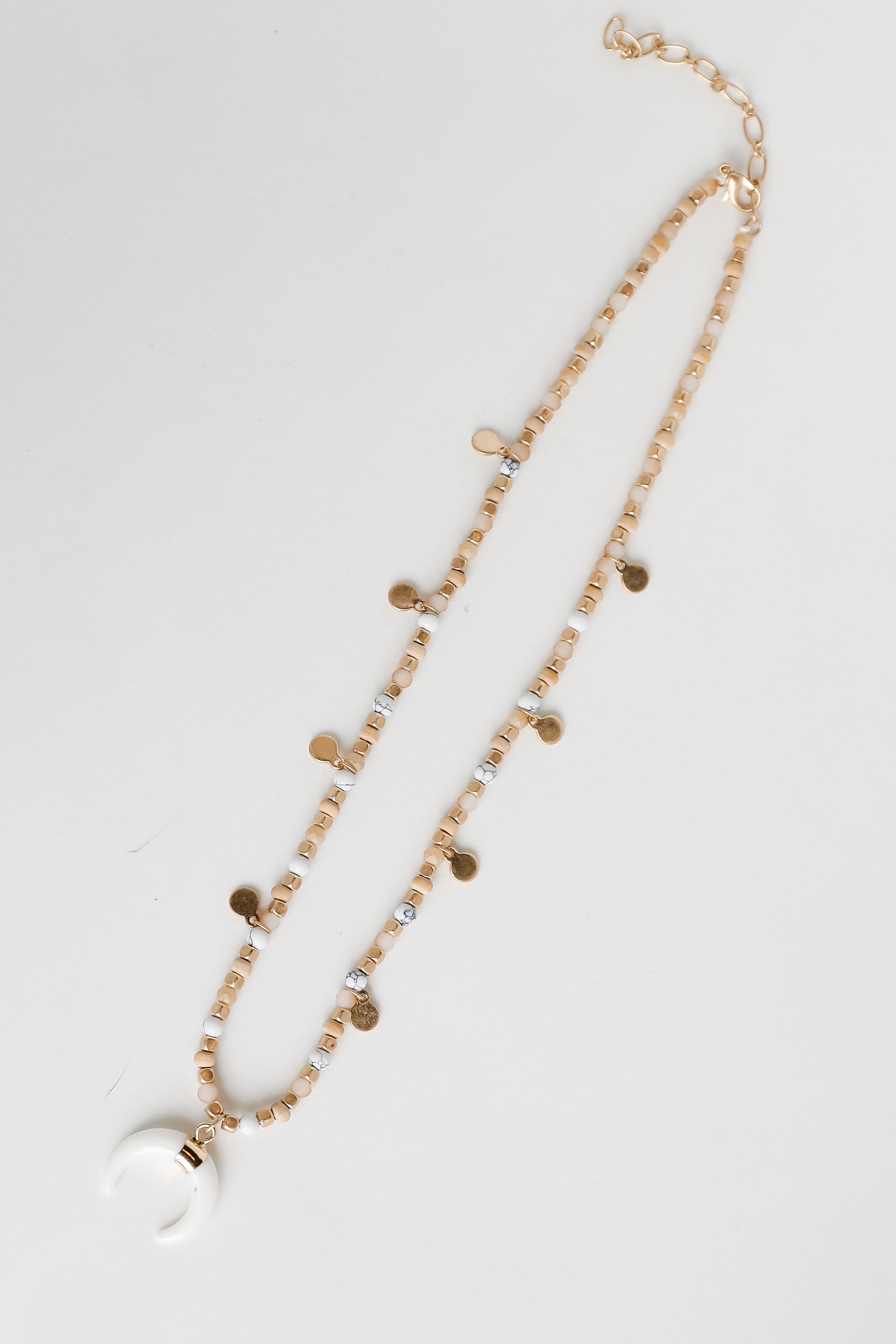 Gold Beaded Crescent Horn Necklace flat lay