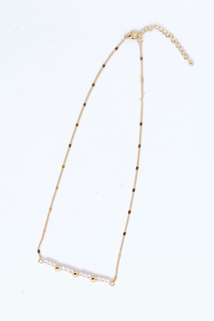 Gold Pearl Bar Necklace flat lay