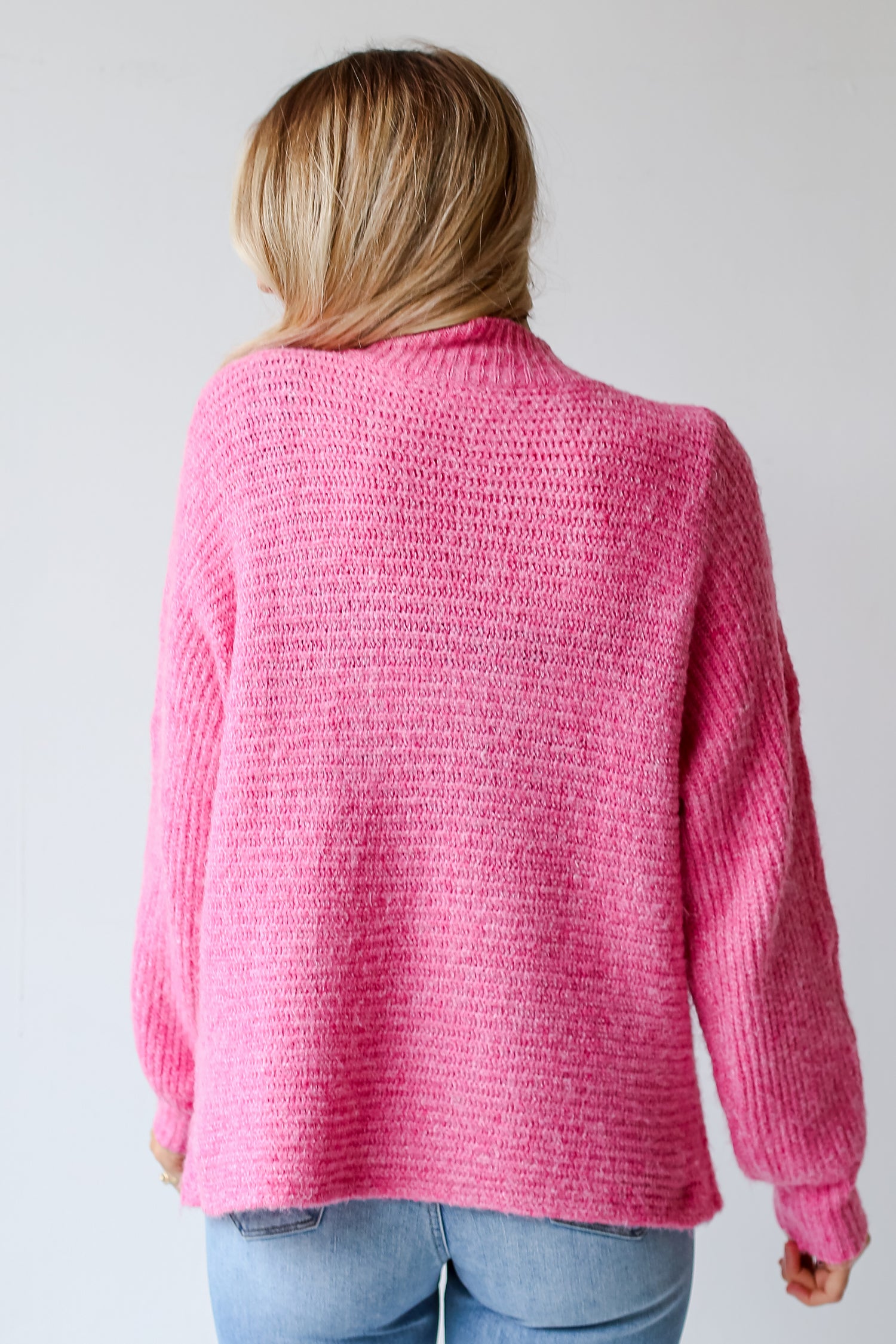 pink sweater back view