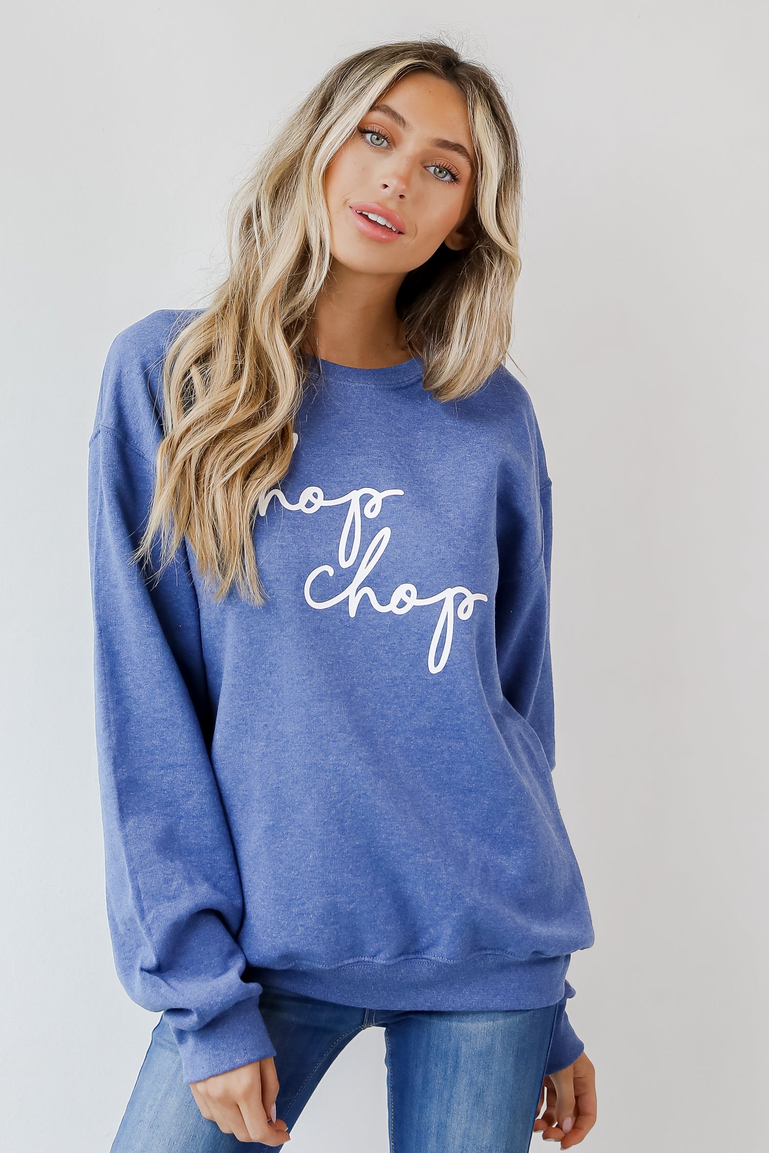 This comfy sweatshirt is designed with a soft and stretchy knit with a fleece interior. It features a crew neckline, long sleeves, a relaxed fit, and the words &quot;Chop Chop&quot; on the front. 