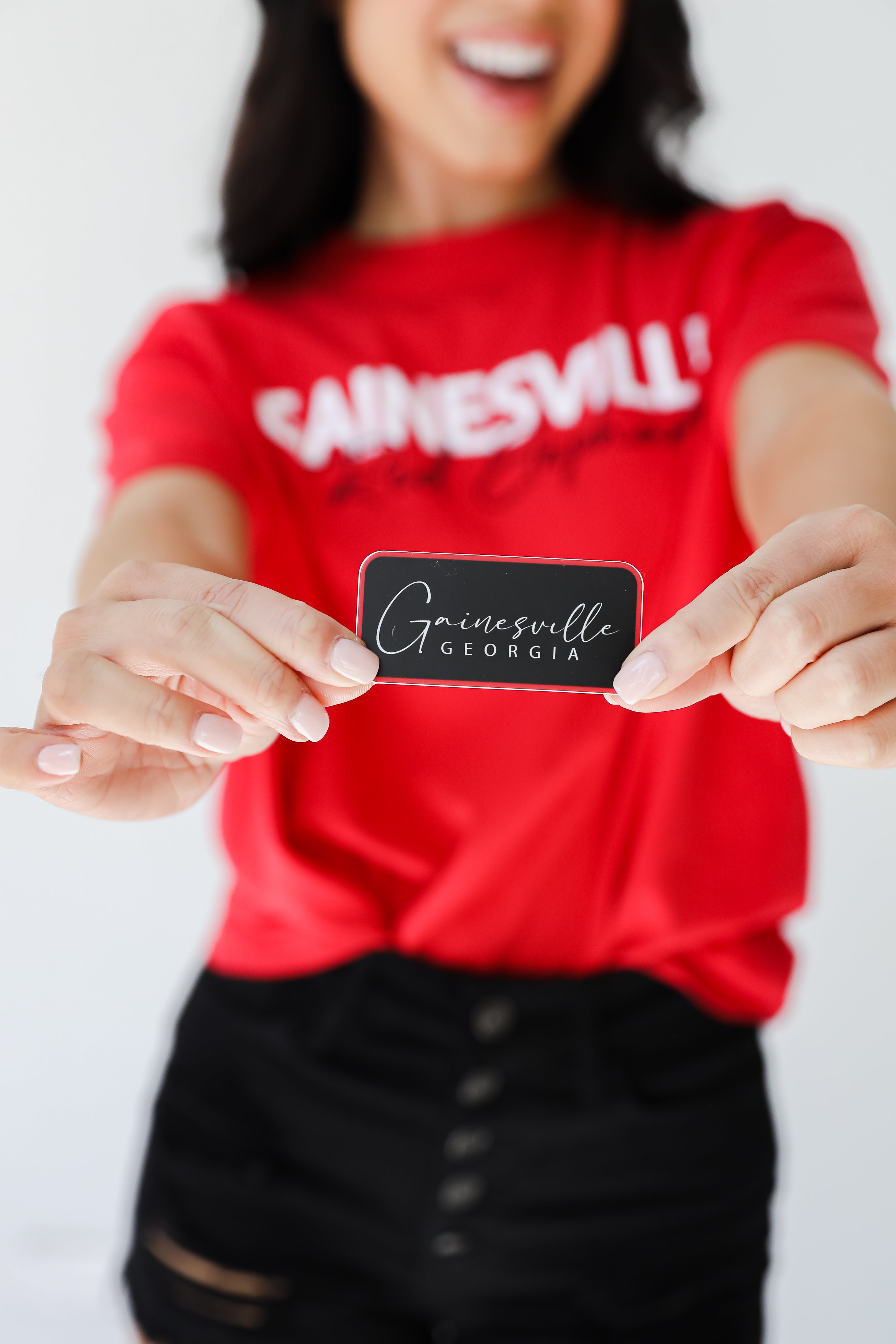 model holding the Gainesville Georgia Sticker