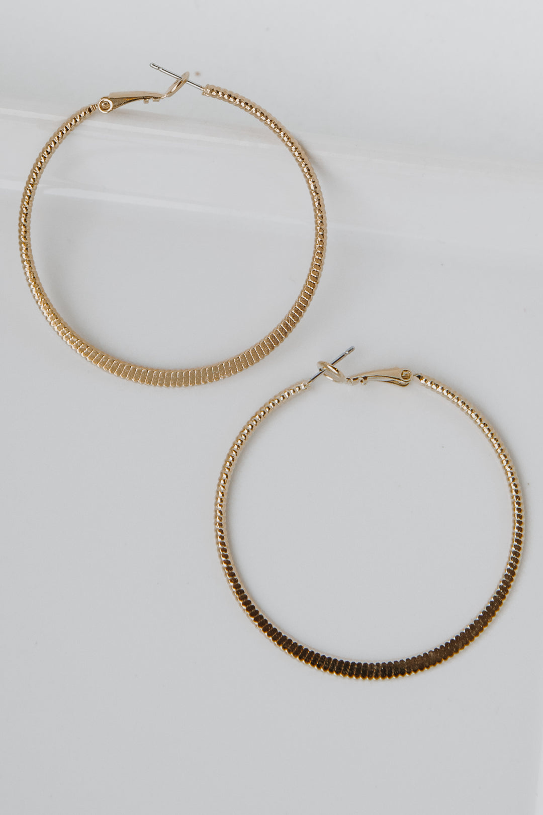 Gold Textured Small Hoop Earrings flat lay